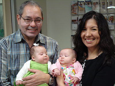 Dr. Diaz with Frozen Egg Baby Grace while Mommy holds twin sister Julia.